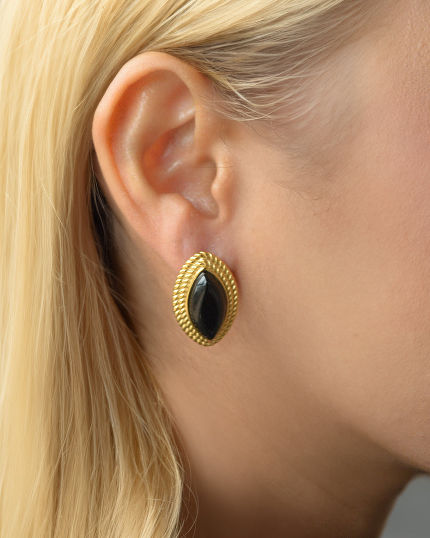 Lena black onyx stud earrings in gold worn on ear – waterproof, tarnish-resistant, and sculptural