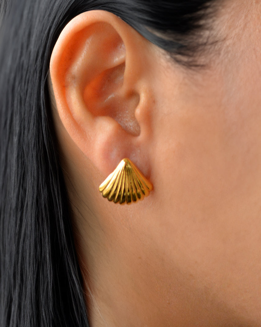 Lior shell-shaped gold earrings on ear – waterproof and refined