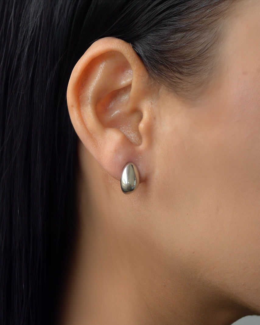Lira silver teardrop stud earrings worn on ear – waterproof and tarnish-resistant