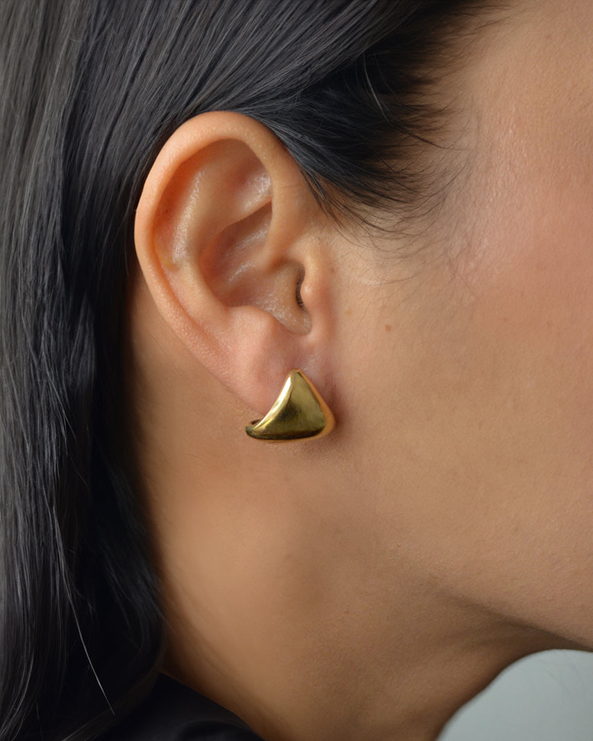 Lugo sculptural gold stud earrings on ear – bold, waterproof and lightweight