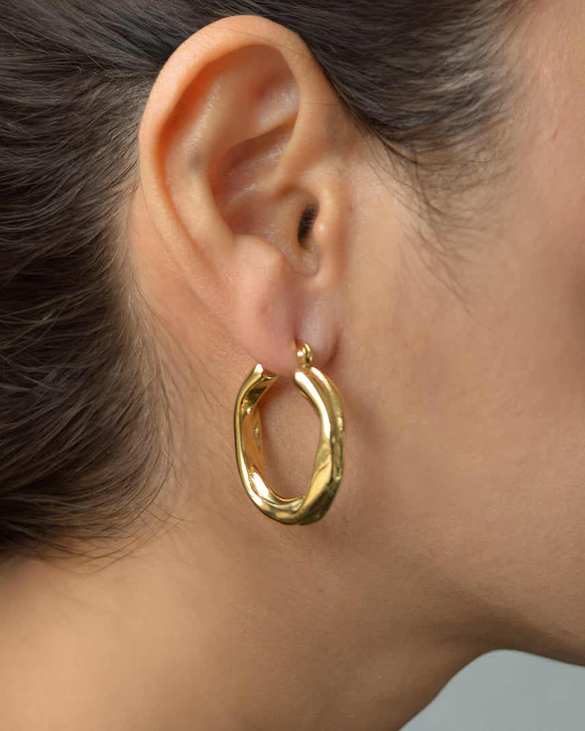Luz gold twist hoop earrings worn on ear – everyday and elegant