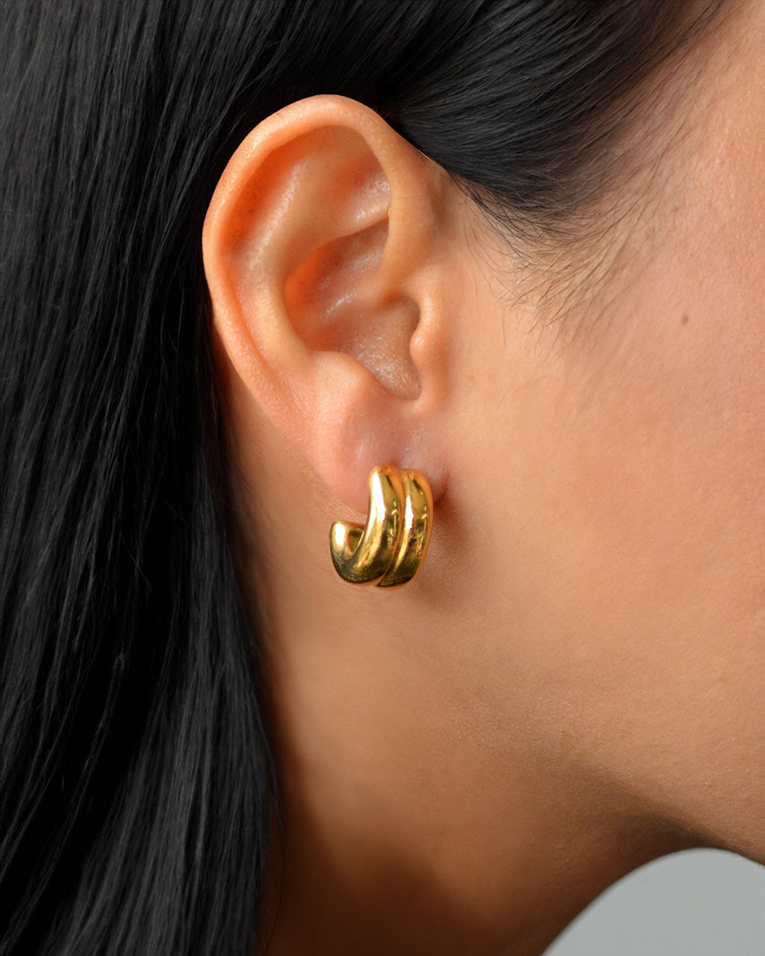 Lynx ridged gold hoops on ear – bold and waterproof stud earrings