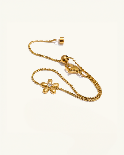 Close-up of flower charm and slider clasp – gold waterproof bracelet with floral design