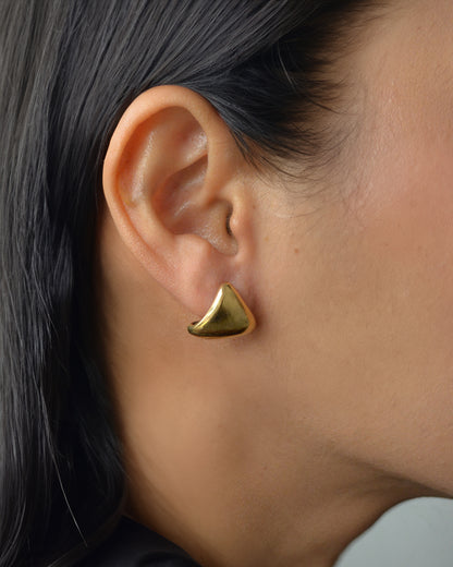 Lugo sculptural gold stud earrings on ear – bold, waterproof and lightweight