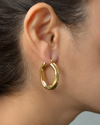 Luz gold twist hoop earrings worn on ear – everyday and elegant