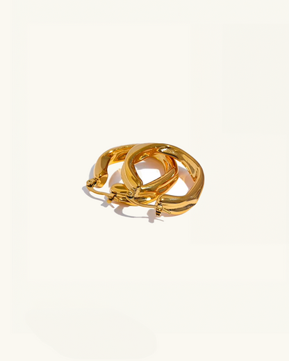 Set of Luz twisted hoop earrings stacked – gold waterproof finish