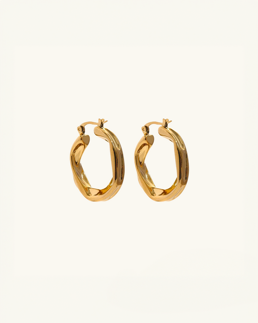 Twisted waterproof gold hoop earrings with a sculptural design